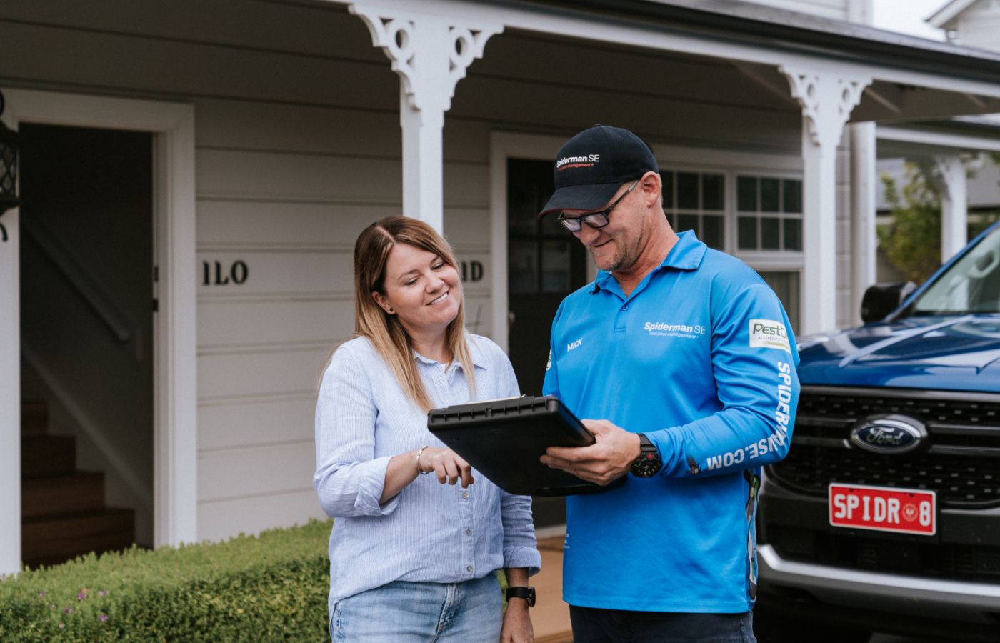 pest control services - termite treatment prevention - happy customer receiving on-site quote