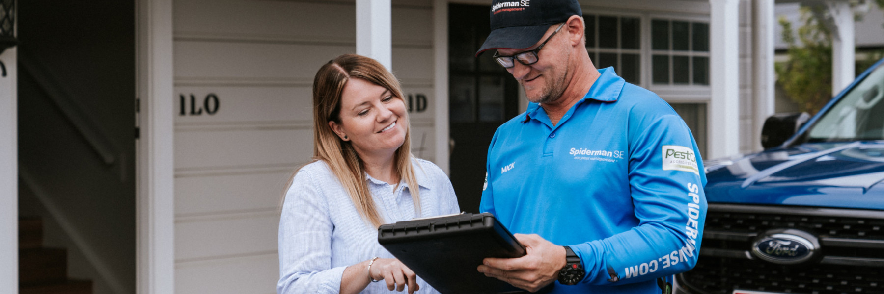 pest control services - termite treatment prevention - happy customer receiving on-site quote